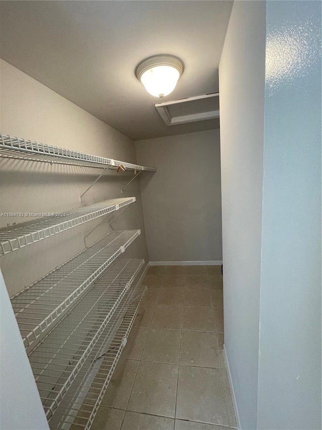 walk in closet with tile patterned floors