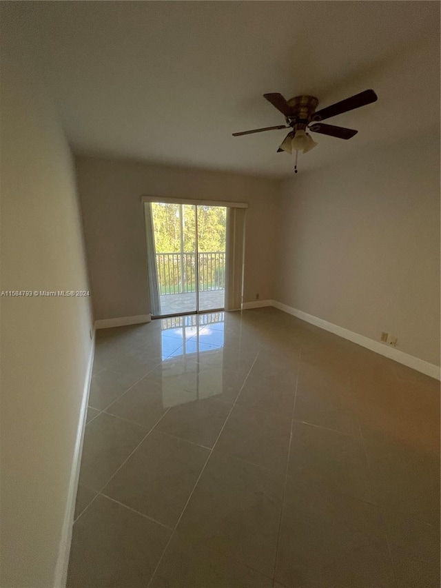 unfurnished room featuring tile patterned floors and ceiling fan