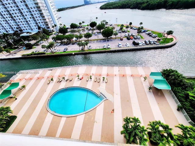 view of swimming pool with a water view