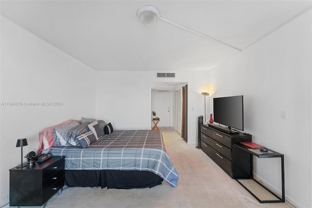 bedroom featuring light carpet