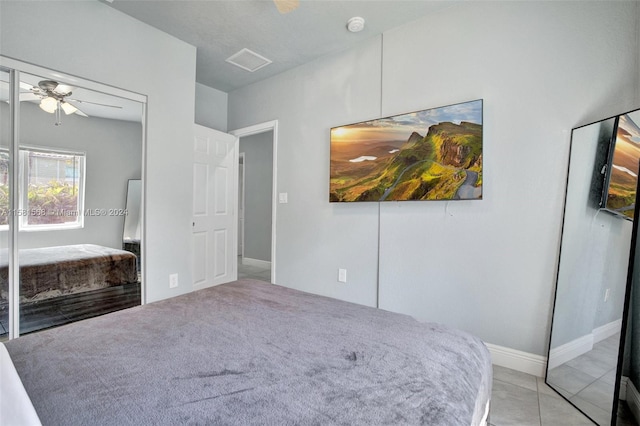 tiled bedroom featuring ceiling fan