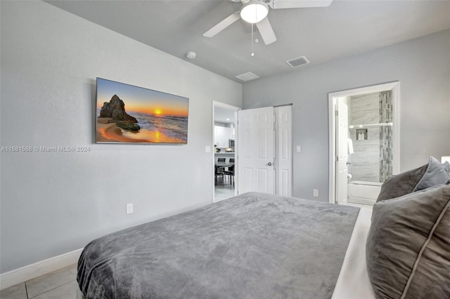 tiled bedroom with ensuite bath and ceiling fan