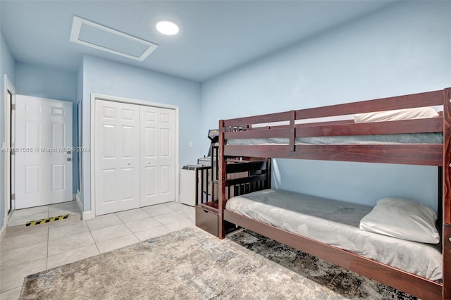 tiled bedroom with a closet