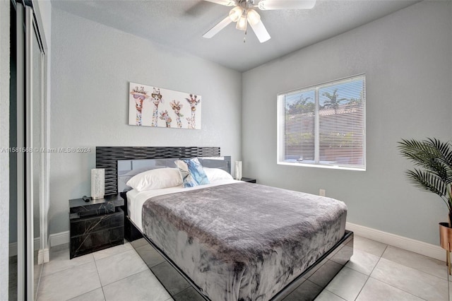 bedroom featuring ceiling fan and light tile floors