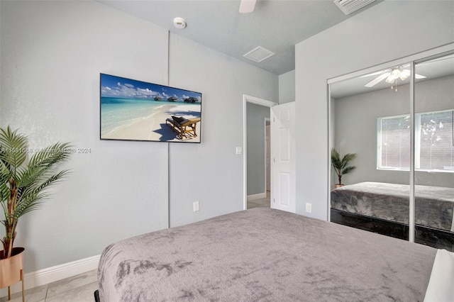 bedroom featuring a closet, ceiling fan, and light tile flooring