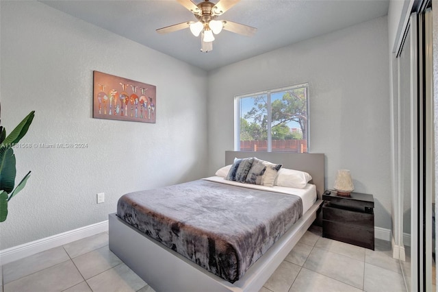 bedroom with ceiling fan and light tile flooring