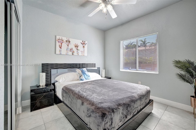 bedroom featuring ceiling fan and light tile floors