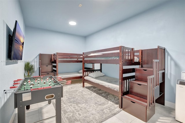 bedroom featuring radiator heating unit and light tile floors