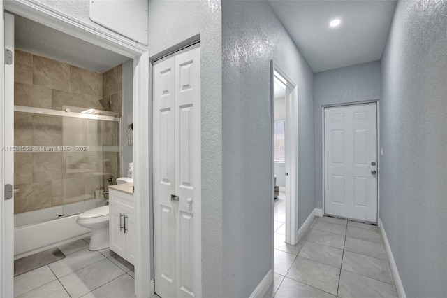 full bathroom featuring vanity, tile floors, toilet, and enclosed tub / shower combo