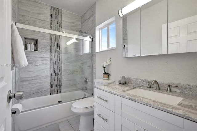 full bathroom with tile flooring, vanity, enclosed tub / shower combo, and toilet