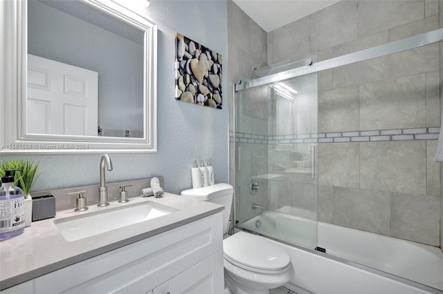 full bathroom featuring oversized vanity, toilet, and enclosed tub / shower combo