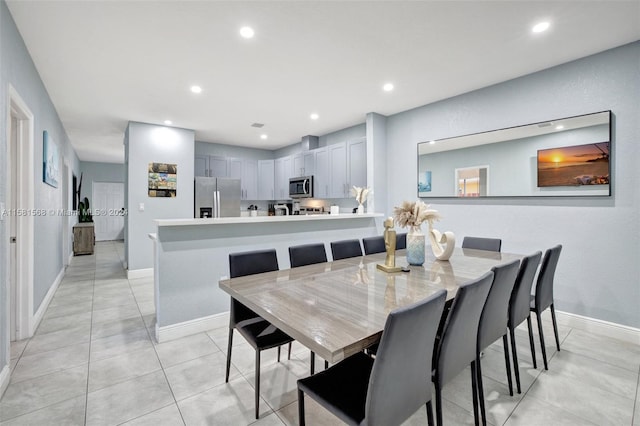 dining area featuring light tile floors