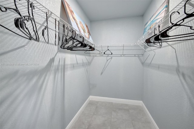 spacious closet featuring tile floors