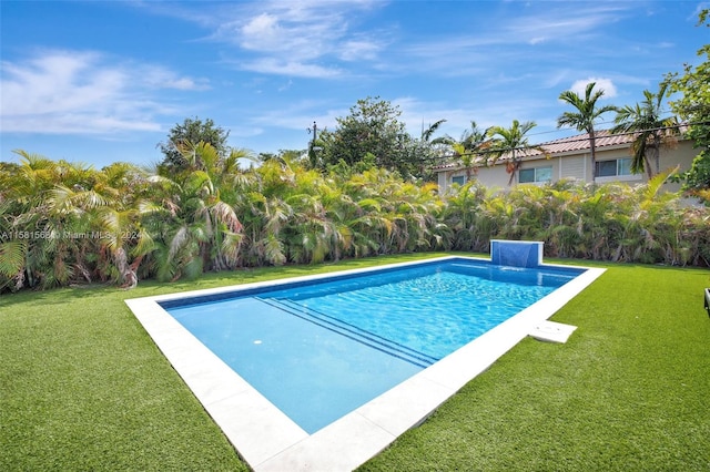 view of swimming pool with a yard