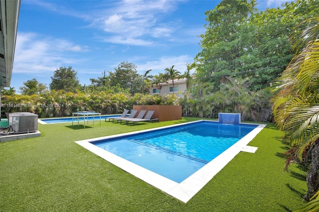 view of pool featuring a yard