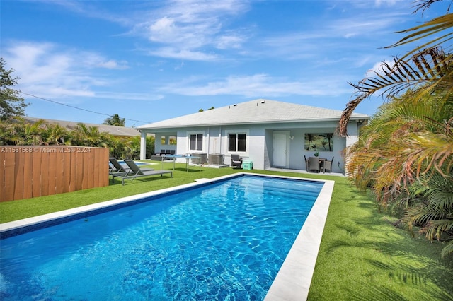 view of swimming pool featuring a patio area and a lawn