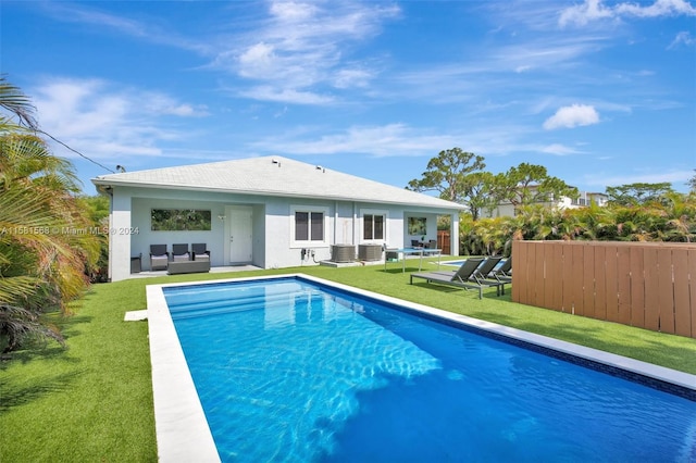 view of swimming pool featuring a yard and a patio area