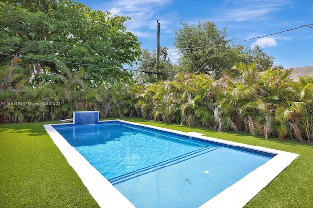 view of swimming pool featuring a lawn