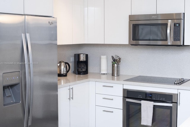 kitchen featuring appliances with stainless steel finishes and white cabinetry