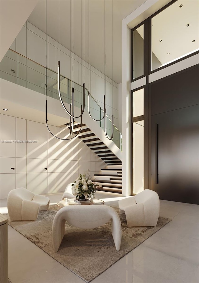 staircase with a high ceiling and concrete flooring