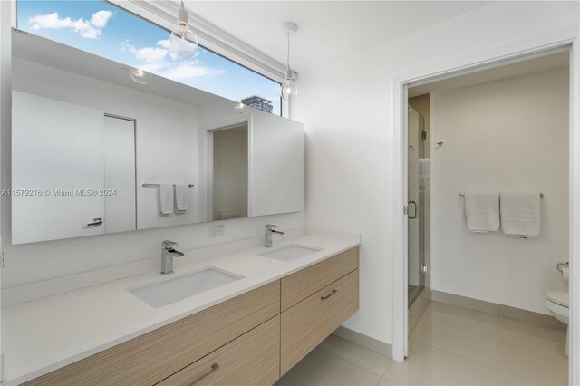 bathroom featuring tile patterned floors, walk in shower, vanity, and toilet