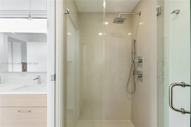 bathroom with vanity, tile patterned flooring, and an enclosed shower