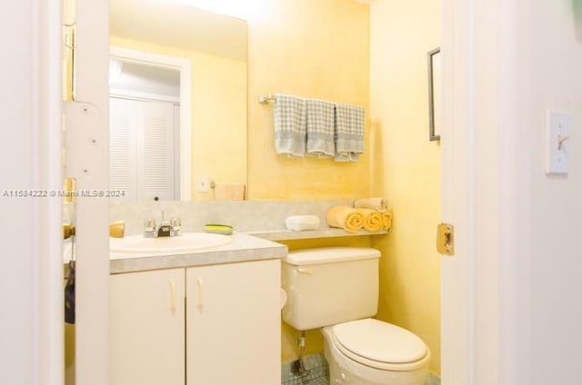 bathroom featuring oversized vanity and toilet