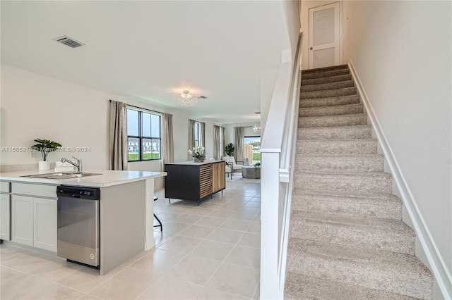 stairs featuring sink and light tile flooring