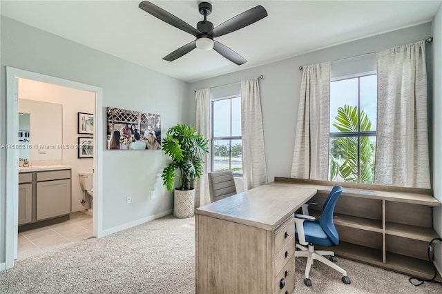 tiled office space featuring ceiling fan