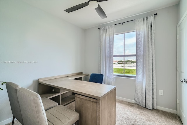 home office featuring light carpet and ceiling fan