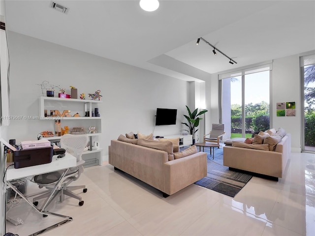 living room featuring floor to ceiling windows, tile floors, and track lighting