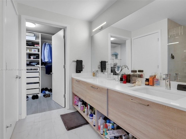 bathroom featuring a shower, vanity, and tile floors