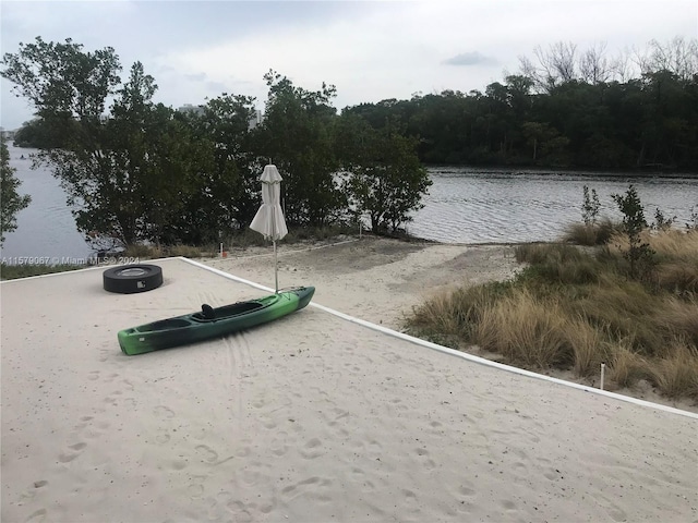 exterior space featuring volleyball court and a water view