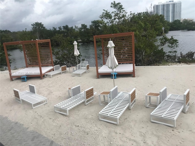 view of patio featuring a pergola and a water view