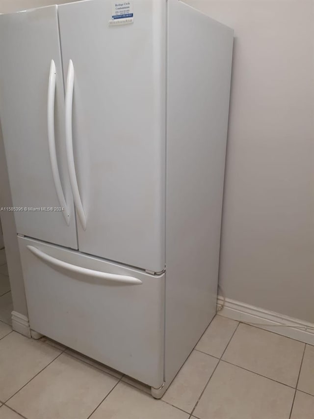 details with white refrigerator and light tile floors