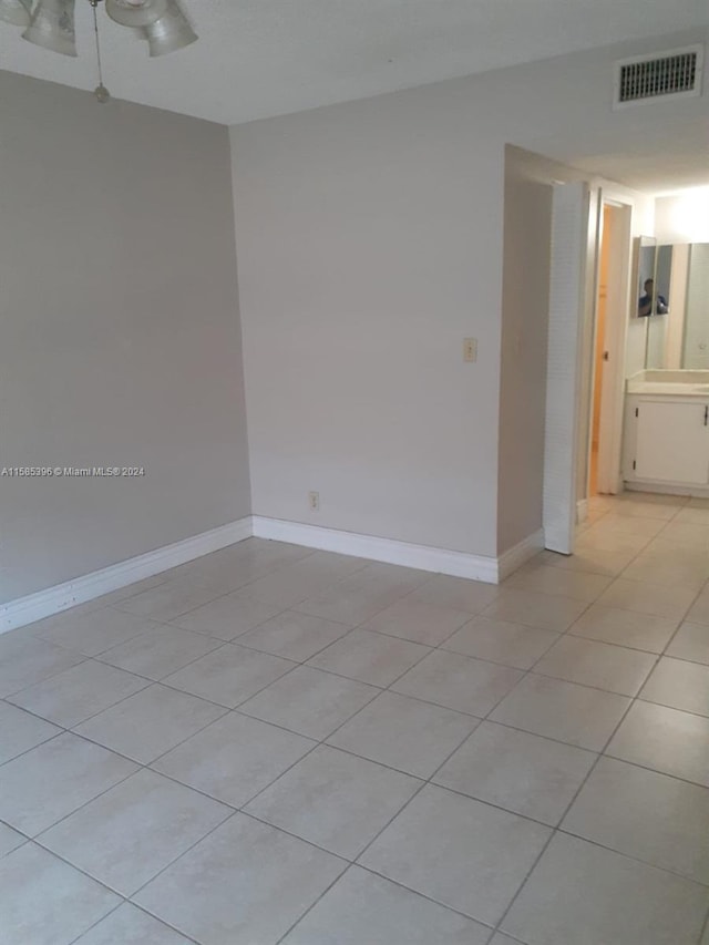 unfurnished room featuring ceiling fan and light tile floors