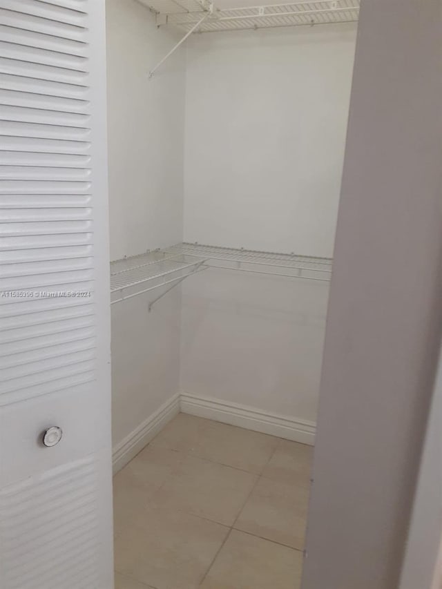 spacious closet featuring tile floors