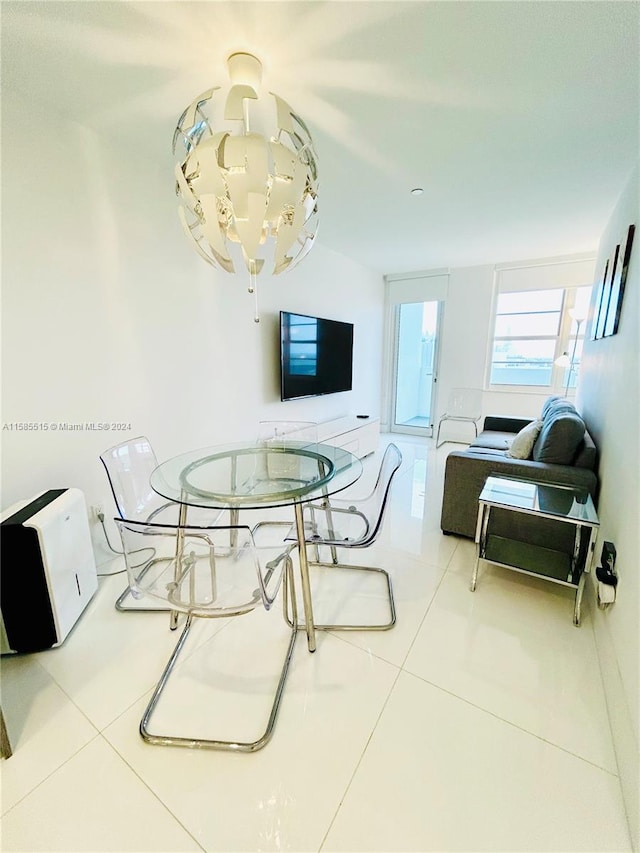 dining area with an inviting chandelier and tile flooring