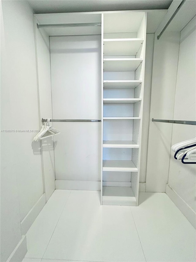 walk in closet featuring tile floors