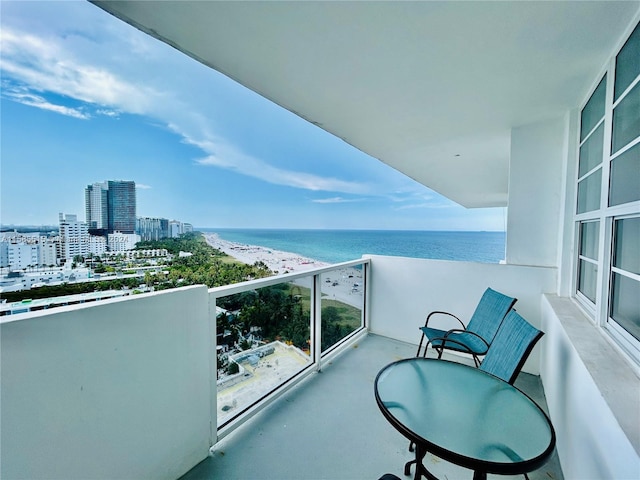 balcony with a beach view and a water view