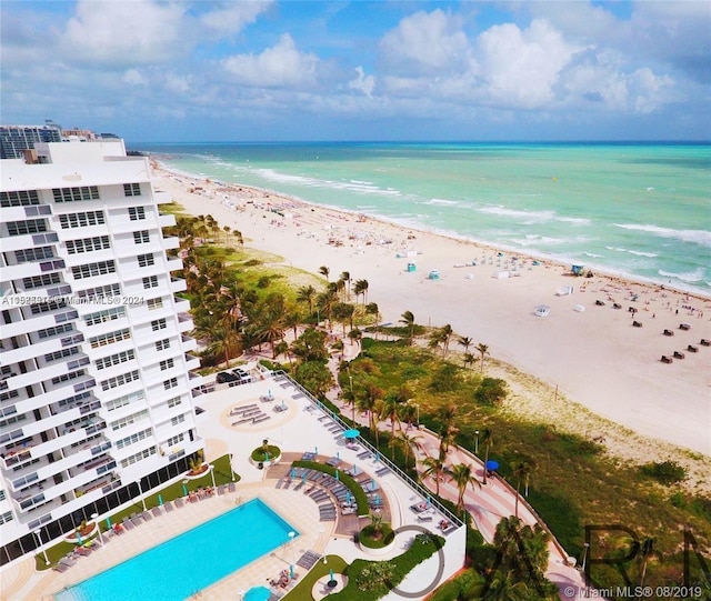 birds eye view of property featuring a beach view and a water view