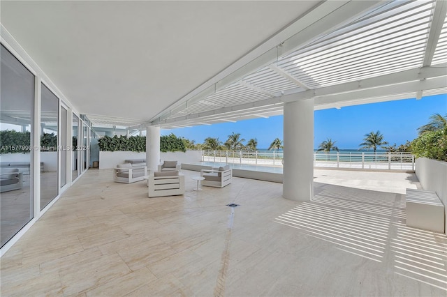 view of patio featuring a water view and a beach view