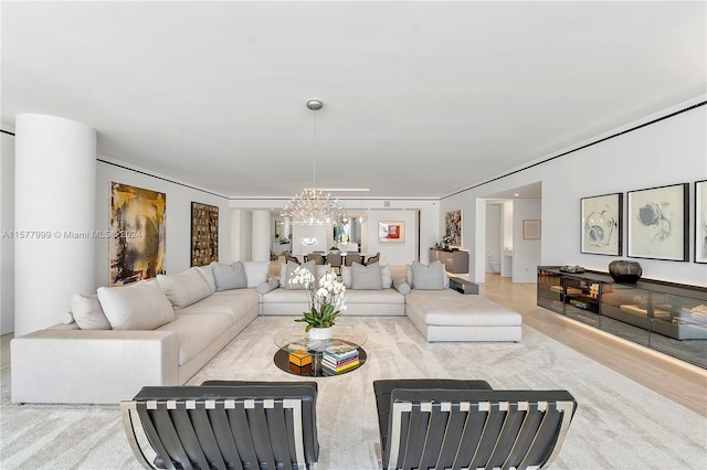 living room featuring light hardwood / wood-style flooring and a chandelier