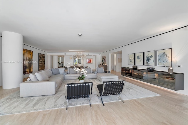 living room featuring an inviting chandelier and light wood-type flooring