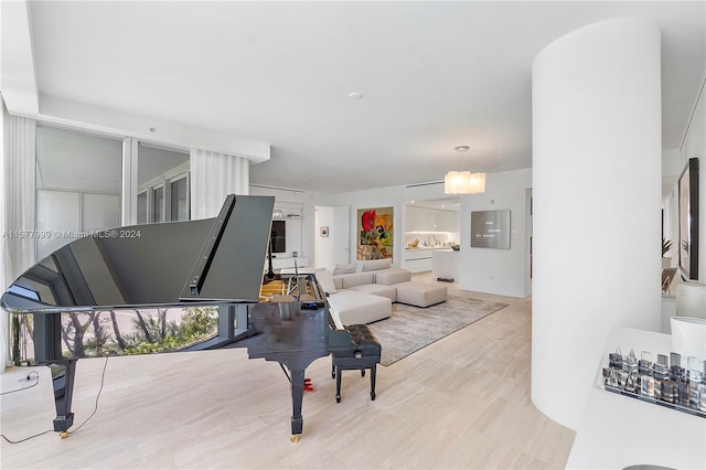 living room with a chandelier and light hardwood / wood-style flooring