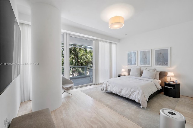 bedroom featuring access to outside and light hardwood / wood-style flooring