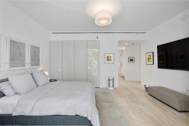 bedroom featuring a closet and light hardwood / wood-style flooring