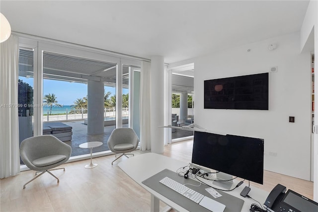 office space featuring floor to ceiling windows and hardwood / wood-style flooring