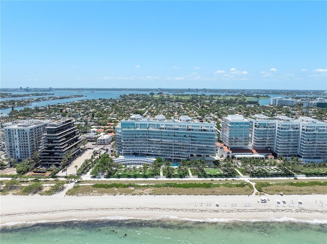 birds eye view of property with a water view and a view of the beach