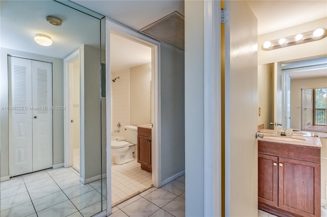 bathroom featuring vanity, toilet, and tile floors